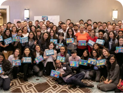 Large group of volunteers holding birthday boxes
