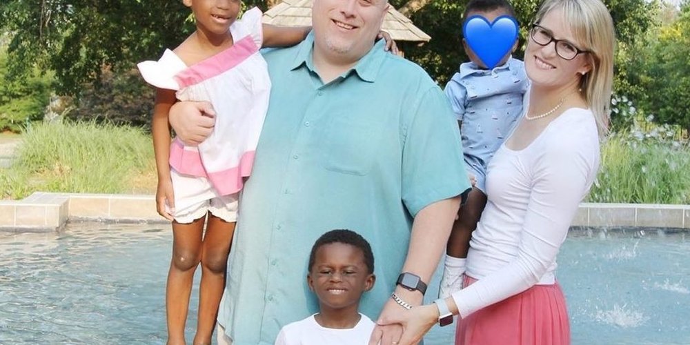 adoptive children being held by parents