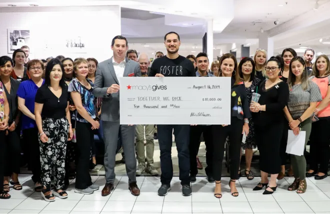 Corporate partners presenting a large donation check