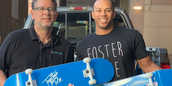 two men holding skateboards for Giving Tuesday preparation