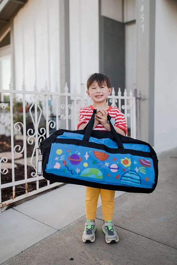 boy holding sweet case luggage for children in foster care