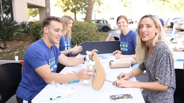 Group building skateboards at a table