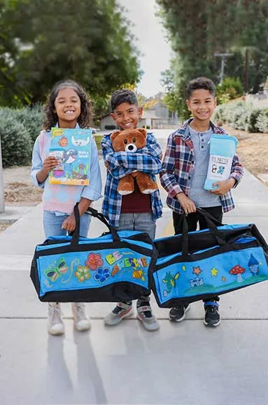 group of kids with sweet case luggage for children in foster care