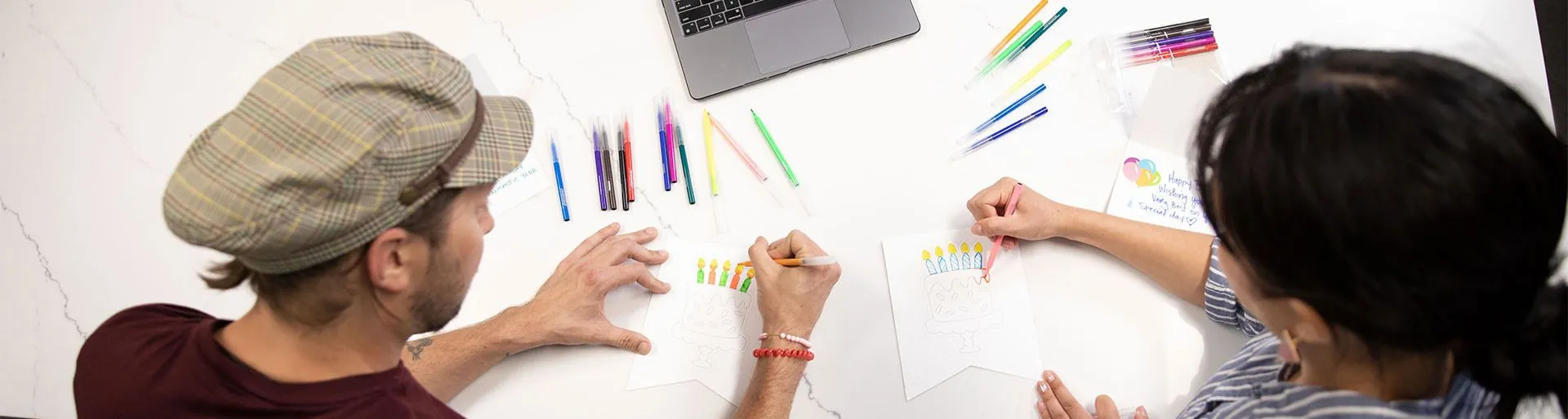 Two people working on a birthday kit