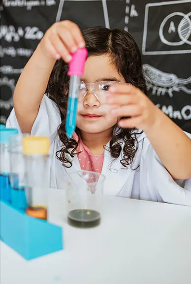 Girl mixing chemicals wearing safety goggles