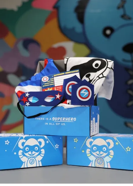 three superhero boxes, one showing off the contents inside
