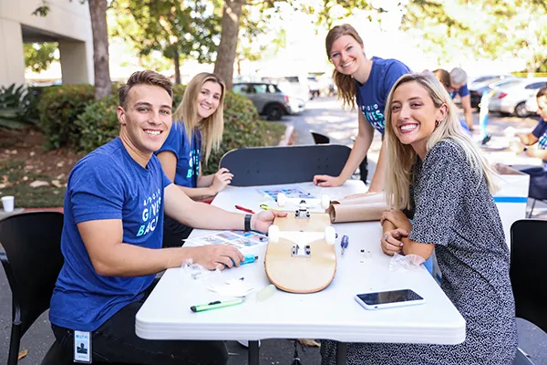 Team building skateboards at a table
