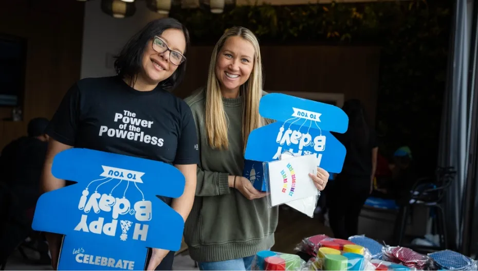 volunteers holding new birthday boxes