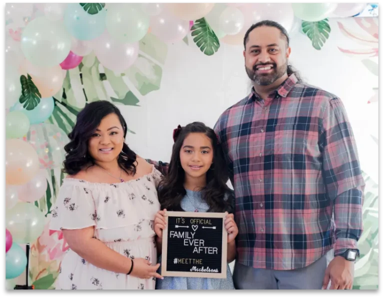 Parents posing with their daughter at a party