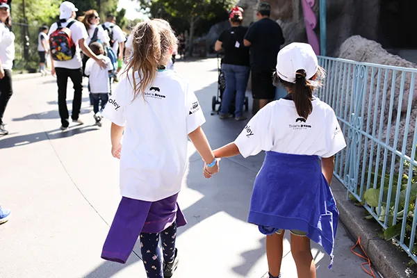 Girls holding hands, back to the camera