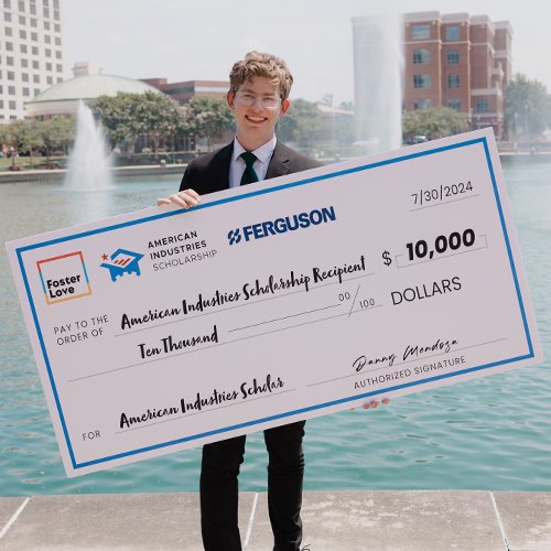 Happy college student receiving a large check from one of Foster Love's foster youth scholarships