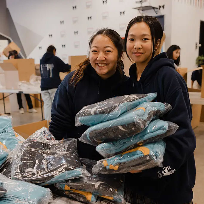 Two women holding donations