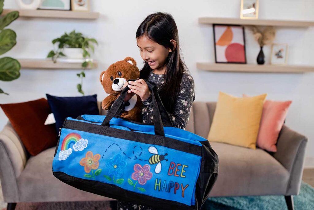 Girl holding duffle bag