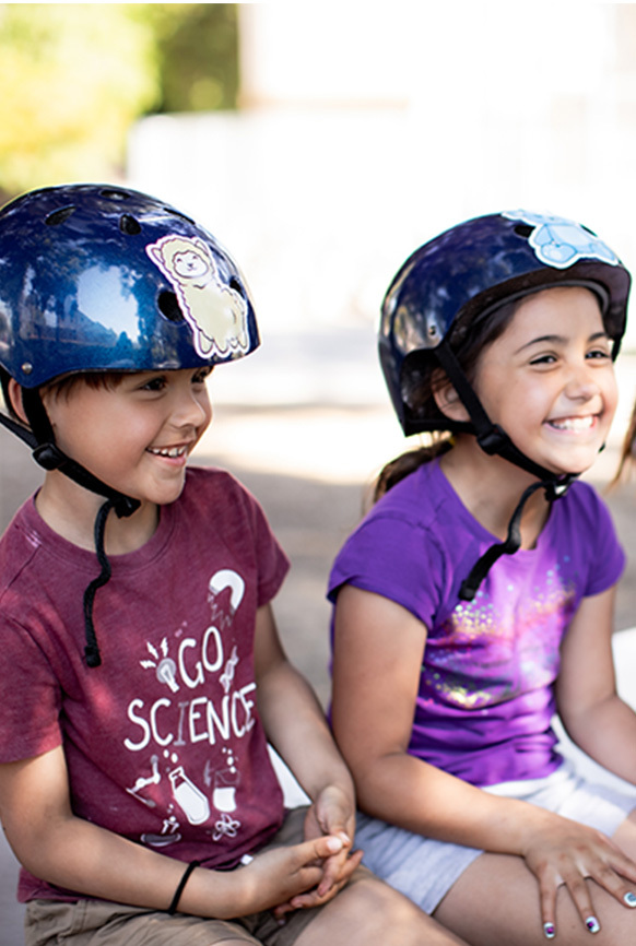 Brother and sister wearing bike helmets