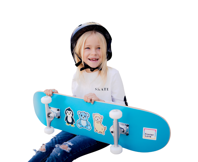 child sitting with their skateboard