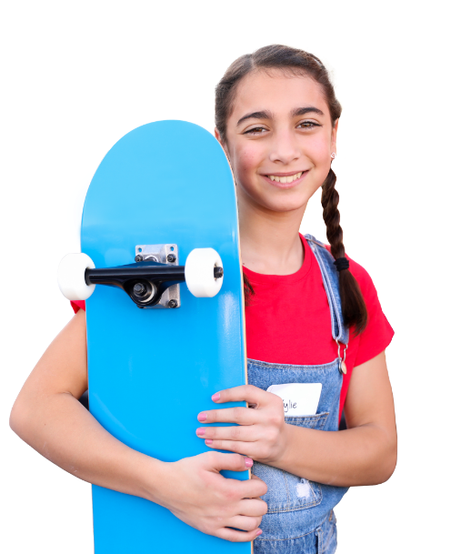 Tween girl standing holding her skateboard
