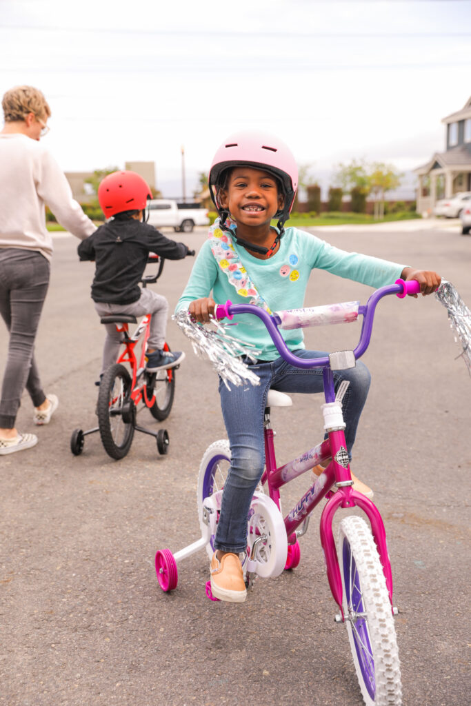 Girl smiling on her new pink bike