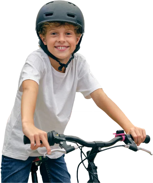 Boy in white riding his bicycle wearing a black helmet