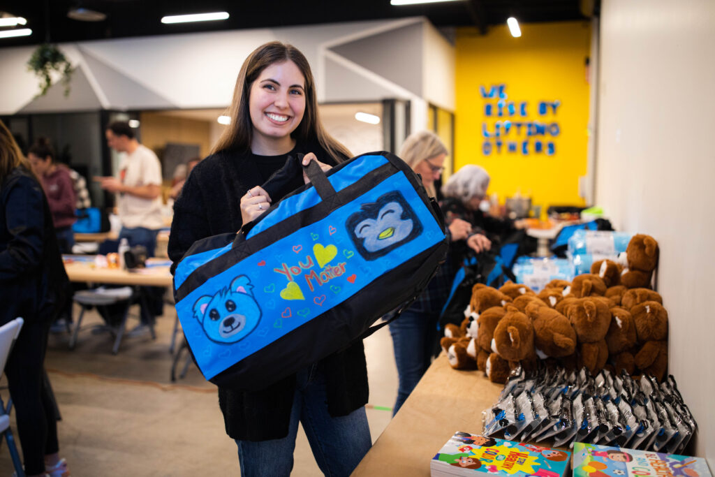Volunteers supporting foster youth with Sweet Case duffle bags