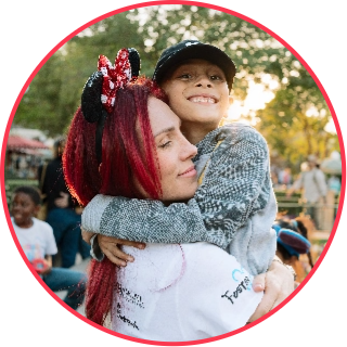 Disney Days volunteer hugging a child