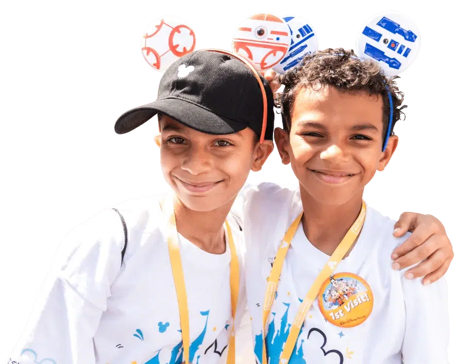 Brothers wearing ears and Disney Days shirts, posing for the camera