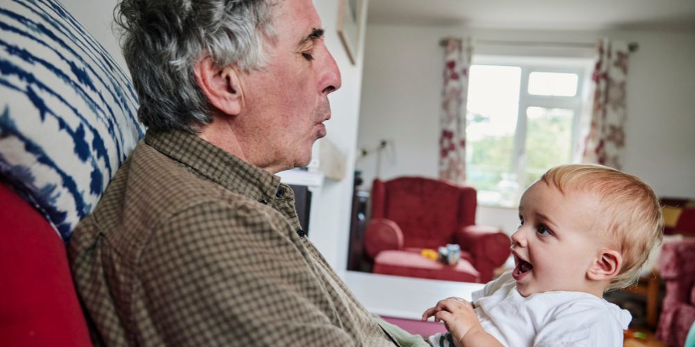 Man with a baby in a kinship caregiving role