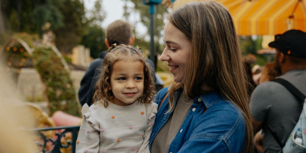 Volunteer holding a little girl