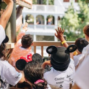 Kids waving to parade with Love Island USA stars at Disney Days