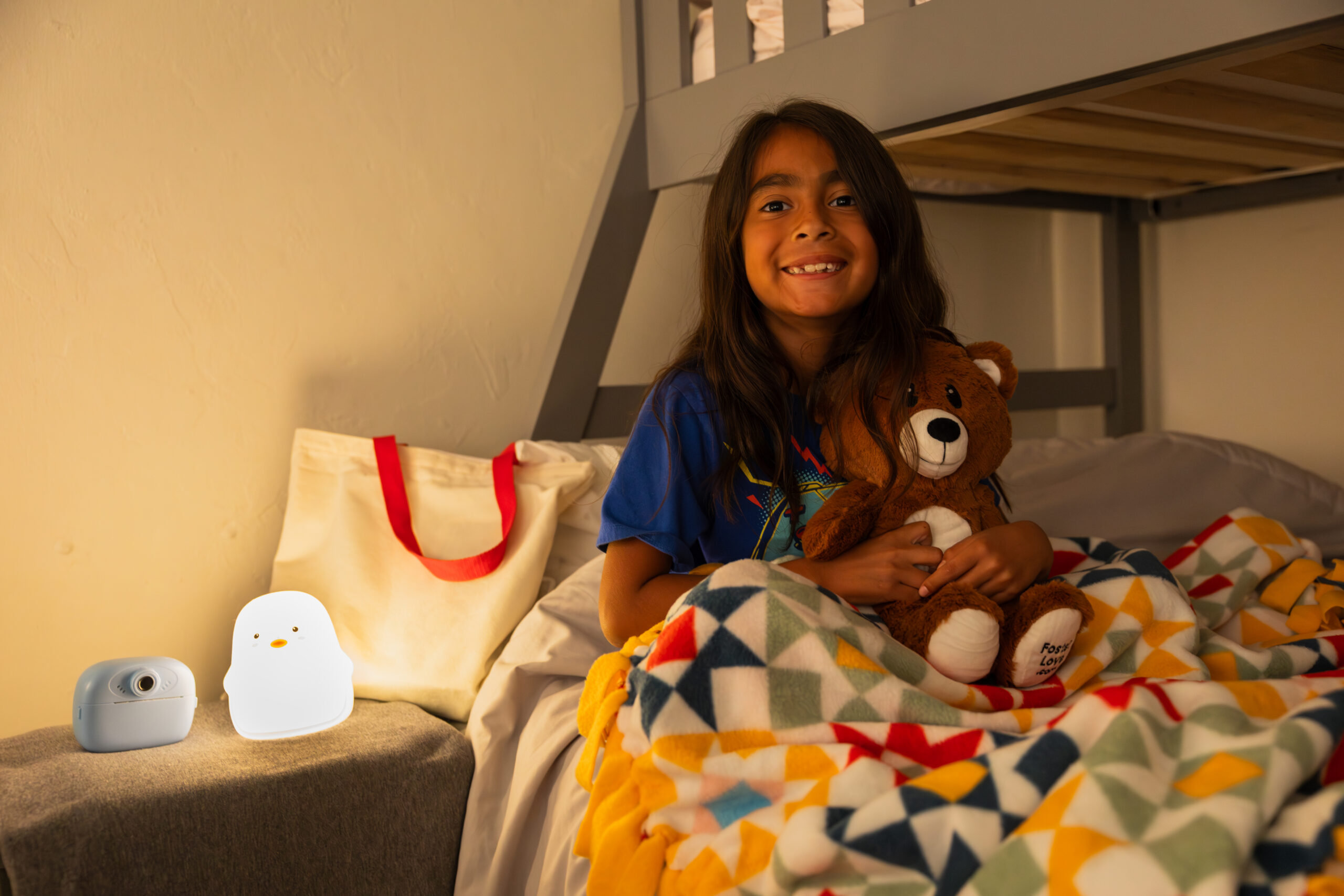 girl sitting with open first night kit items in bed