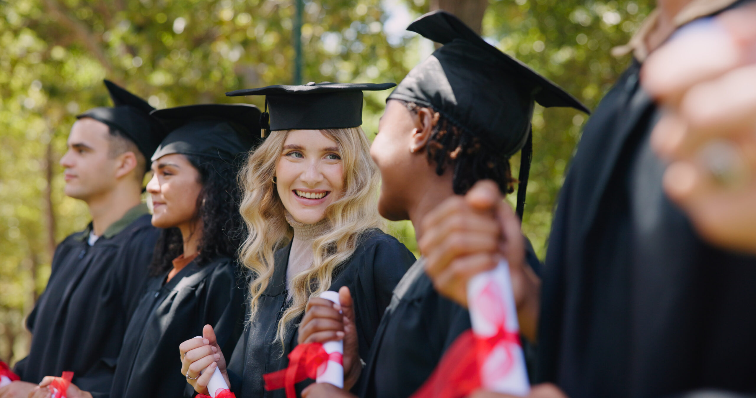 A row of graduates who completed school thanks to the Foster Love Family Fellowship