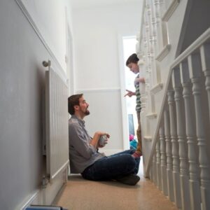 man and son talking by staircase