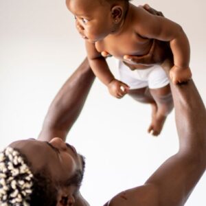 man holding his baby in the arm
