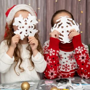 Kids holding snowflake cutouts