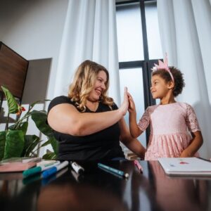woman high-fiving her daughter
