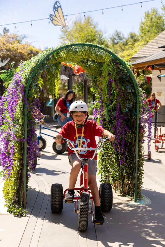 A child at Birthday Palooza riding a bike