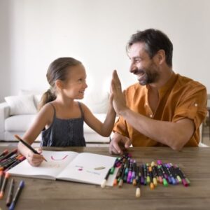 man high fiving his daughter