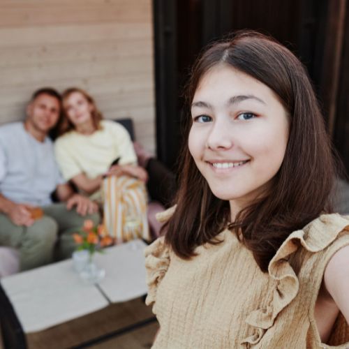 girl taking selfie with her parents