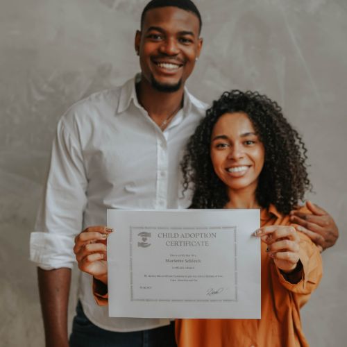 parents holding adoption certificate