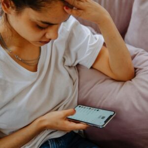 girl looking distressed looking at DMs